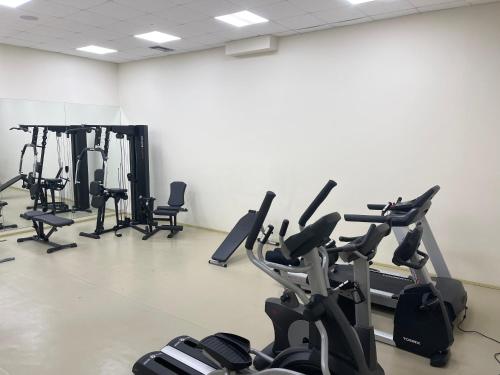a gym with several exercise bikes in a room at Olympian Bay Grand Resort in Leptokarya