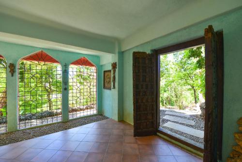 an empty room with an open door to a yard at Biancas Garden Apartments Boracay in Boracay