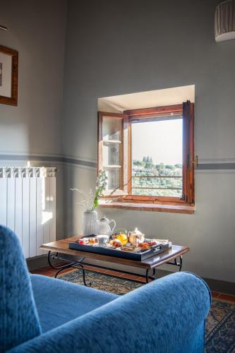 a living room with a tray of food on a table at Relais Villa Olmo - Place of Charme in Impruneta