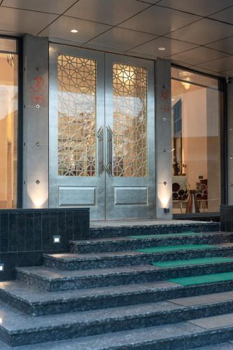 a set of stairs in front of a building with a door at The Greenwood Guwahati - A Luxury Boutique Hotel in Guwahati