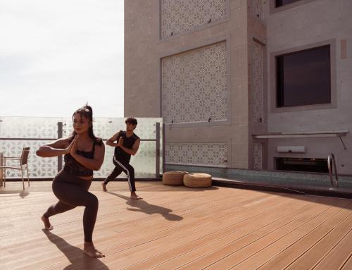a couple of people doing yoga in a room at The Greenwood Guwahati - A Luxury Boutique Hotel in Guwahati