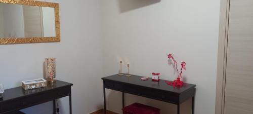 a bathroom with a black vanity and a mirror at B&B LE BACETTE in Caprarola