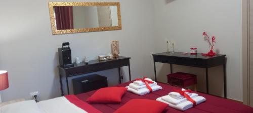 a bedroom with a bed with red and white towels on it at B&B LE BACETTE in Caprarola