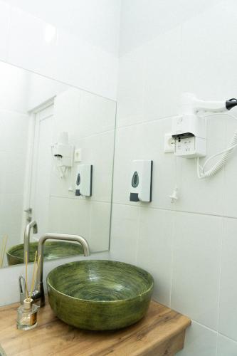 a bathroom with a green sink and a mirror at Jardin in Aktobe