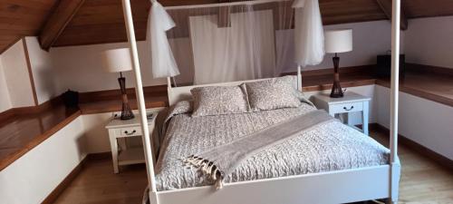 a bedroom with a canopy bed with two night stands at Hotel valle de lago in Valle de Lago