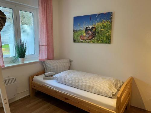 a bed in a room with a picture on the wall at Allgäutraum Ferienwohnung Nr. 1 in Kempten