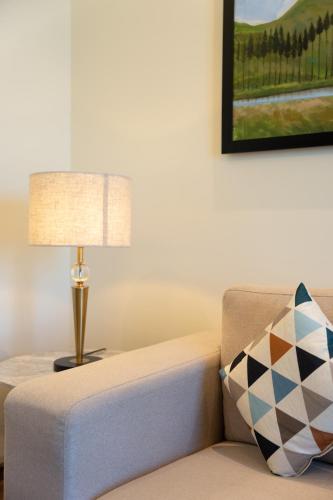 a living room with a lamp and a couch at The Greenwood Guwahati - A Luxury Boutique Hotel in Guwahati