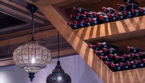 a row of wine bottles and a chandelier at DECAN Concept Boutique Estate in Rhodes Town