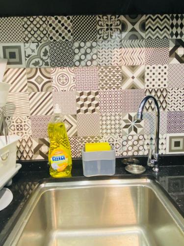 a kitchen sink with a bottle of dish detergent next to it at Vista Bangi Soho UKM, Swimming pool & River view in Kajang