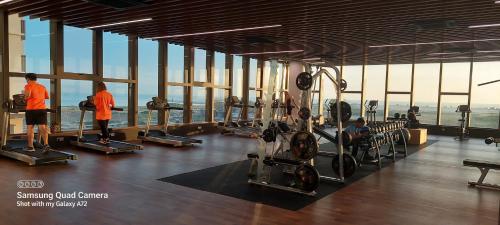 a gym with people in orange shirts looking out the window at Bali Residence Az Zahra Raudhah- Muslim friendly in Melaka