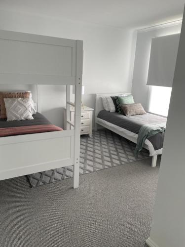 a bedroom with two bunk beds and a mirror at McCracken Homestay in McCracken