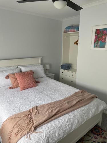 a bedroom with a bed with a brown blanket on it at McCracken Homestay in McCracken