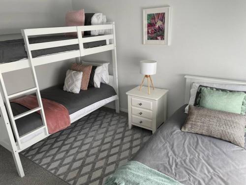 a bedroom with two bunk beds and a bed at McCracken Homestay in McCracken
