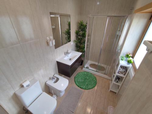 a bathroom with a toilet and a sink and a shower at Room Dream Beato in Lisbon