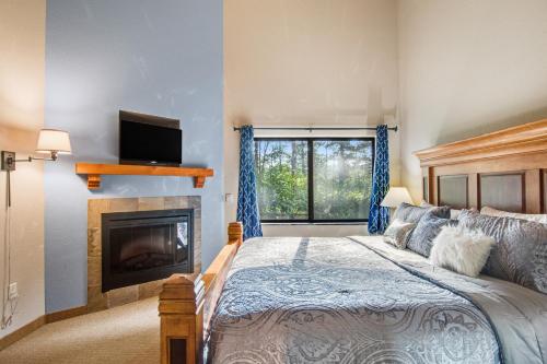 a bedroom with a bed and a fireplace at Chula Vista Condo Unit #2145 in Wisconsin Dells