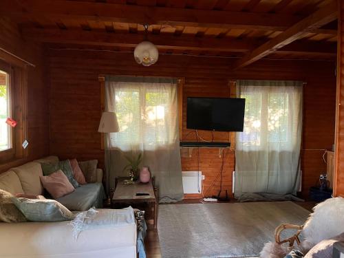 a living room with a couch and a flat screen tv at Kisház in Gárdony