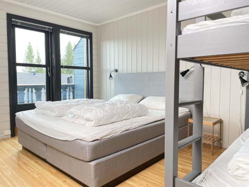 a bedroom with a bunk bed with a ladder at Bakkebyvegen 20A in Trysil