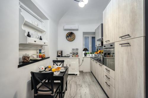 a small kitchen with a table and chairs in it at Imperial Rhome Guest House in Rome