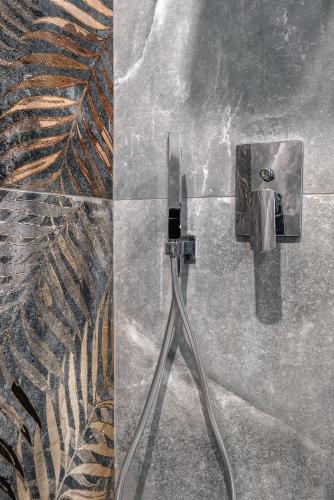 a shower with a hose plugged into a wall at Imperial Rhome Guest House in Rome