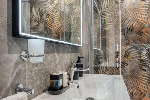 a bathroom with a sink and a mirror at Imperial Rhome Guest House in Rome