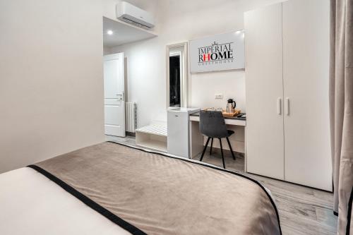 a bedroom with a bed and a desk with a chair at Imperial Rhome Guest House in Rome