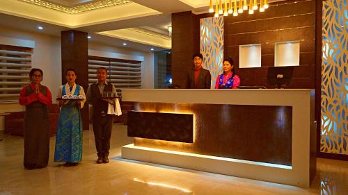 a group of people standing in a lobby at ShriGo Hotel Gangtok in Gangtok