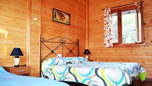 a bedroom with a bed in a wooden wall at Apartamentos Paraje San Gines in Andújar