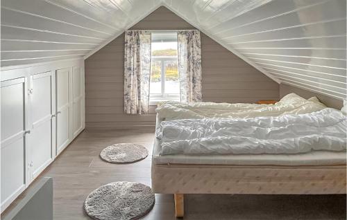 a attic bedroom with a bed and a window at Awesome Home In Straumsjen With 3 Bedrooms And Wifi in Straumsjøen