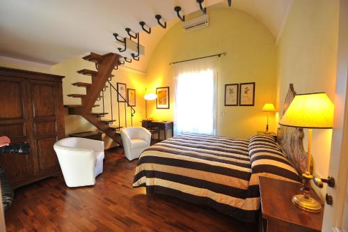 a bedroom with a bed with a striped blanket at Relais Casabella in Martina Franca