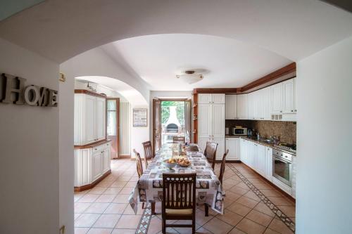 a large kitchen with a long table with chairs at Charming & Luxury Villa Como Lake in Como