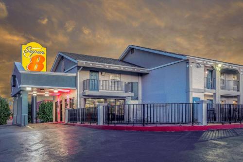 a building with a sign on the side of it at Super 8 by Wyndham Tulsa/Arpt/St Fairgrounds in Tulsa
