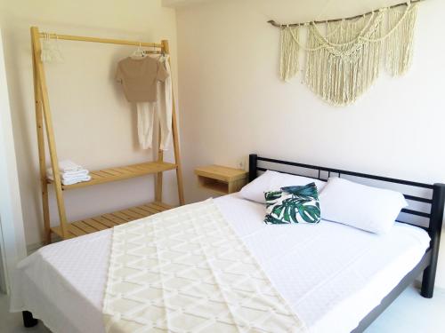 a bedroom with a bed with a white comforter at Santa Suites- Near Saint Nicholas Church in Demre