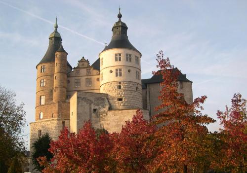a castle with two towers on top of it at Appart'Hôtel de la Gare - Cocooning in Montbéliard