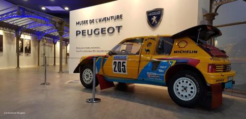 a yellow race car on display in a museum at Appart'Hôtel de la Gare - Cocooning in Montbéliard