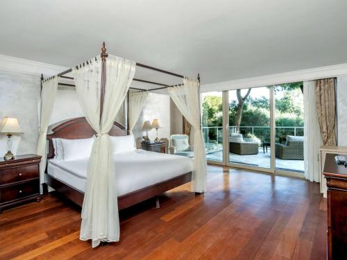a bedroom with a bed with a canopy at Club Prive By Rixos Belek in Belek