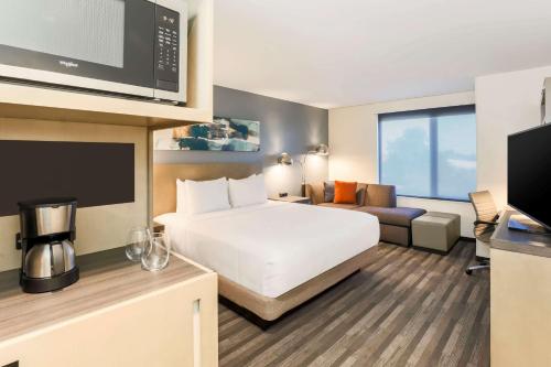 a hotel room with a bed and a tv at Hyatt House Davis in Davis