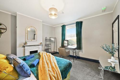 a living room with a bed and a fireplace at Central Free Parking Luxury House in Oxford