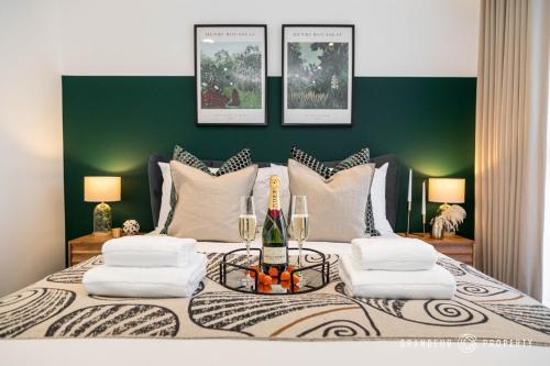 a bedroom with a large bed with a green wall at Aurora Heights by Grandeur Property in Poole