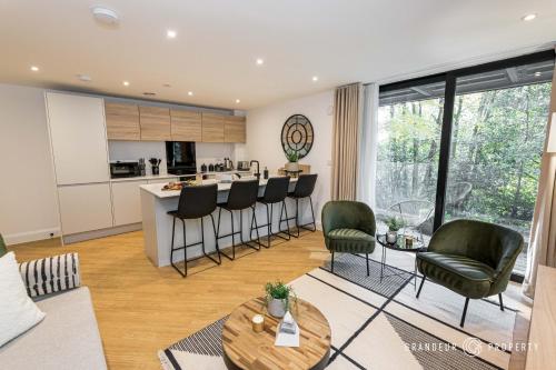 a kitchen and living room with a table and chairs at Aurora Heights by Grandeur Property in Poole