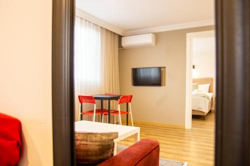 a room with a table and chairs and a bed at Colorful and Central Flat near Kulturpark Izmir in Izmir