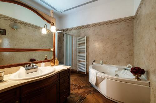a bathroom with a tub and a sink and a mirror at Charming & Luxury Villa Como Lake in Como