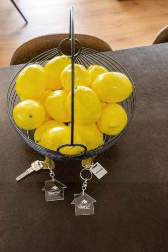 a bowl of yellow fruit on top of a table at El Séptimo, Apartamento in Gijón