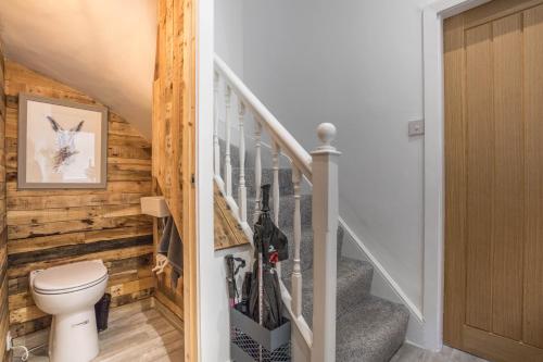 a staircase with a toilet in a house at Town Centre Haven Mountain Views Urban Convenience in Ambleside