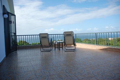 two chairs and a table on a balcony at E&J Boutique Residences in Sosúa