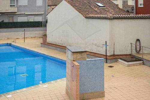a swimming pool in a yard with a building at Casina de Dante in San Juan de la Arena