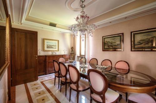 a dining room with a glass table and chairs at Charming & Luxury Villa Como Lake in Como