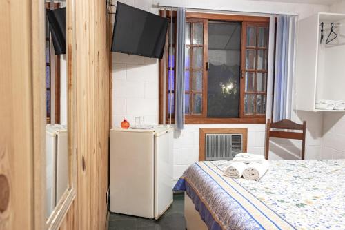Tempat tidur dalam kamar di Pousada Estrela da Manhã