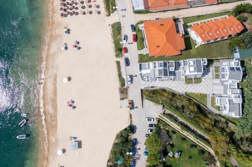 an overhead view of a beach with buildings and the ocean at The Black Pearl Villas in Kalamitsi