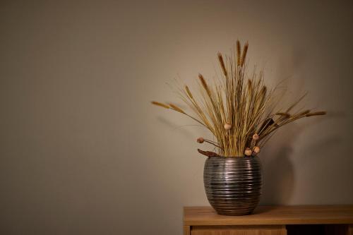 a vase with grass in it sitting on a table at Zum Roten Bären in Freiburg im Breisgau