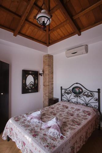 a bedroom with a large bed with a floral blanket at Villa Aelia in Alonnisos